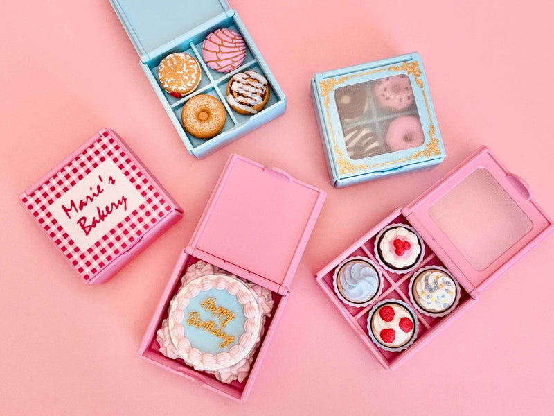 Printed bakery boxes with donuts, conchas and a small birthday cake inside