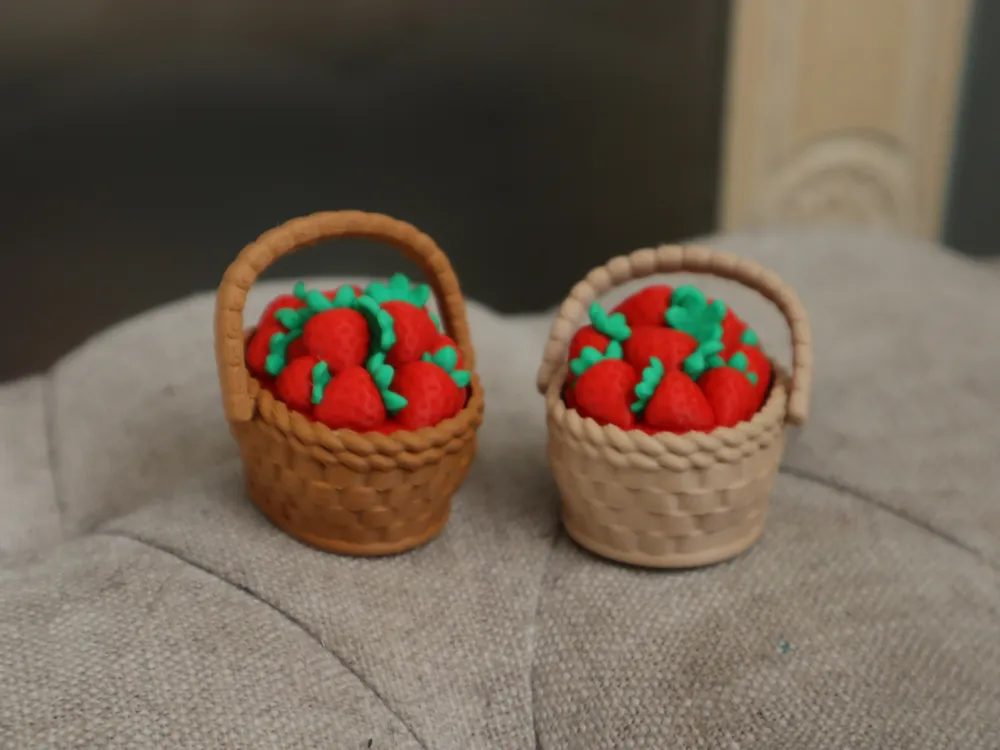 Two woven baskets heaped with printed strawberries